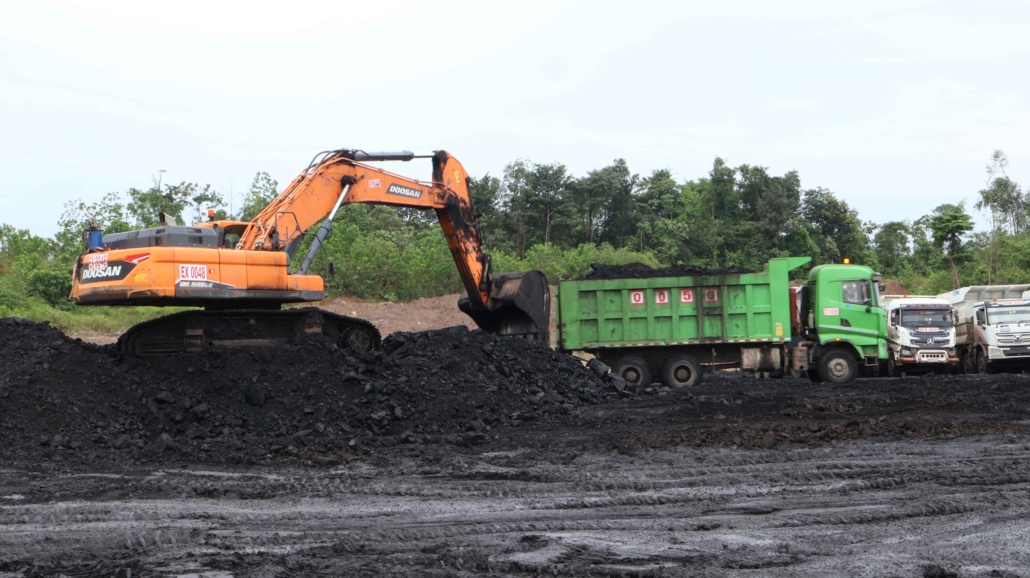 Open-pit coal mine in Kalimantan with heavy mining equipment